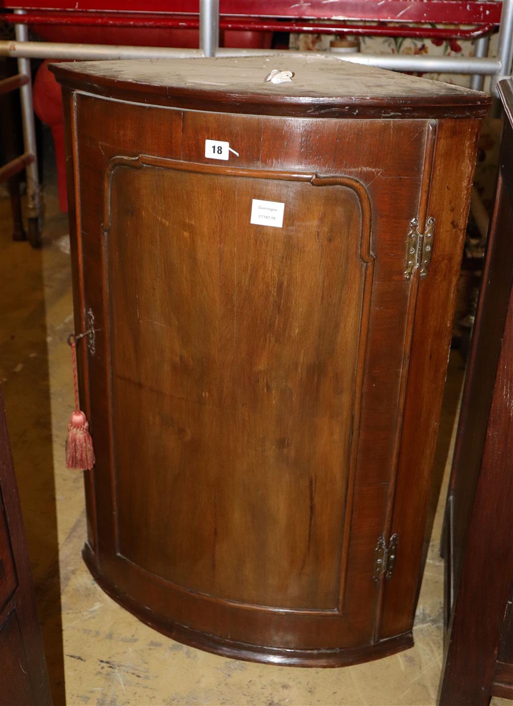 A George III walnut bowfront hanging corner cabinet, width 62cm, depth 42cm, height 88cm